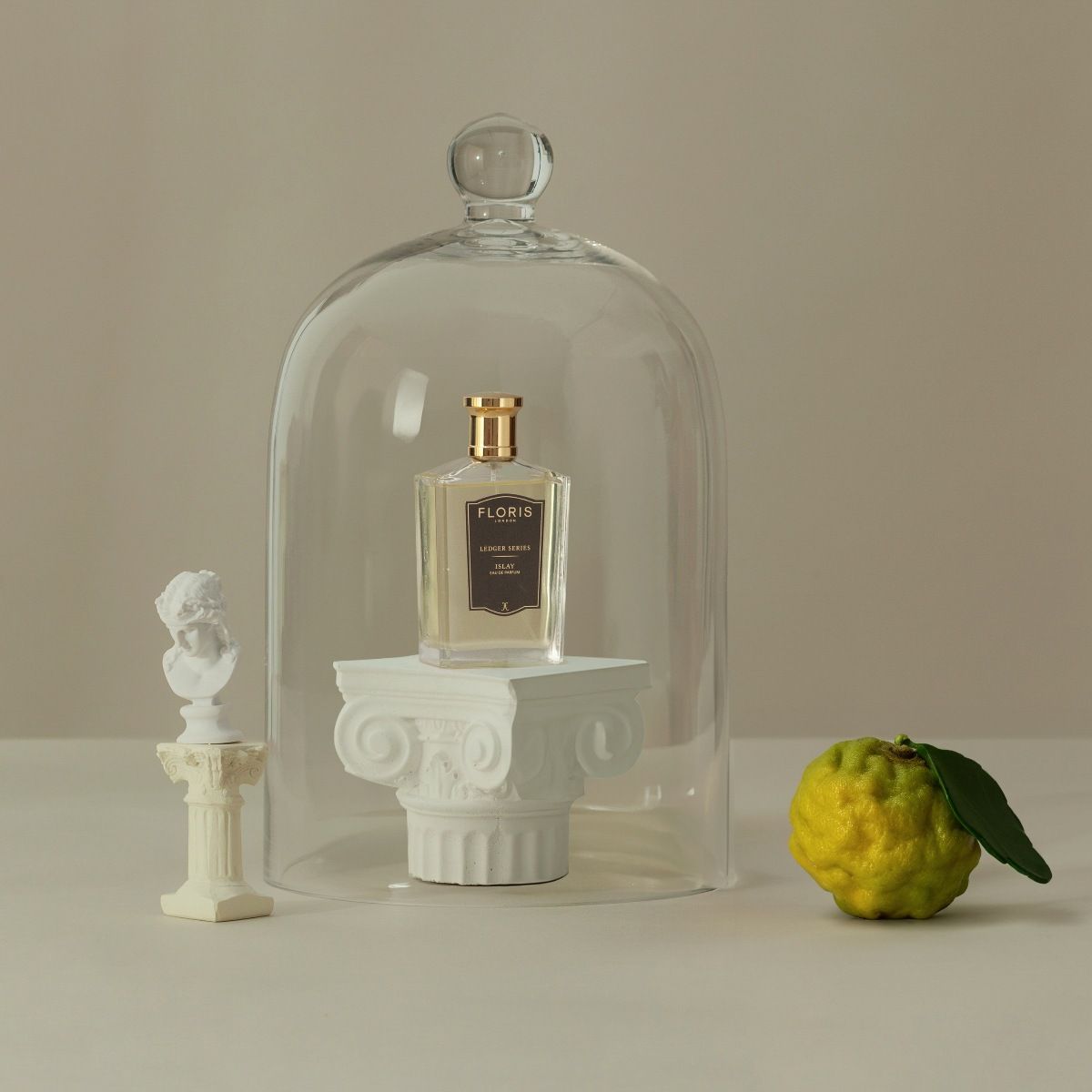 Islay shown with a bell jar and bergamot fruit